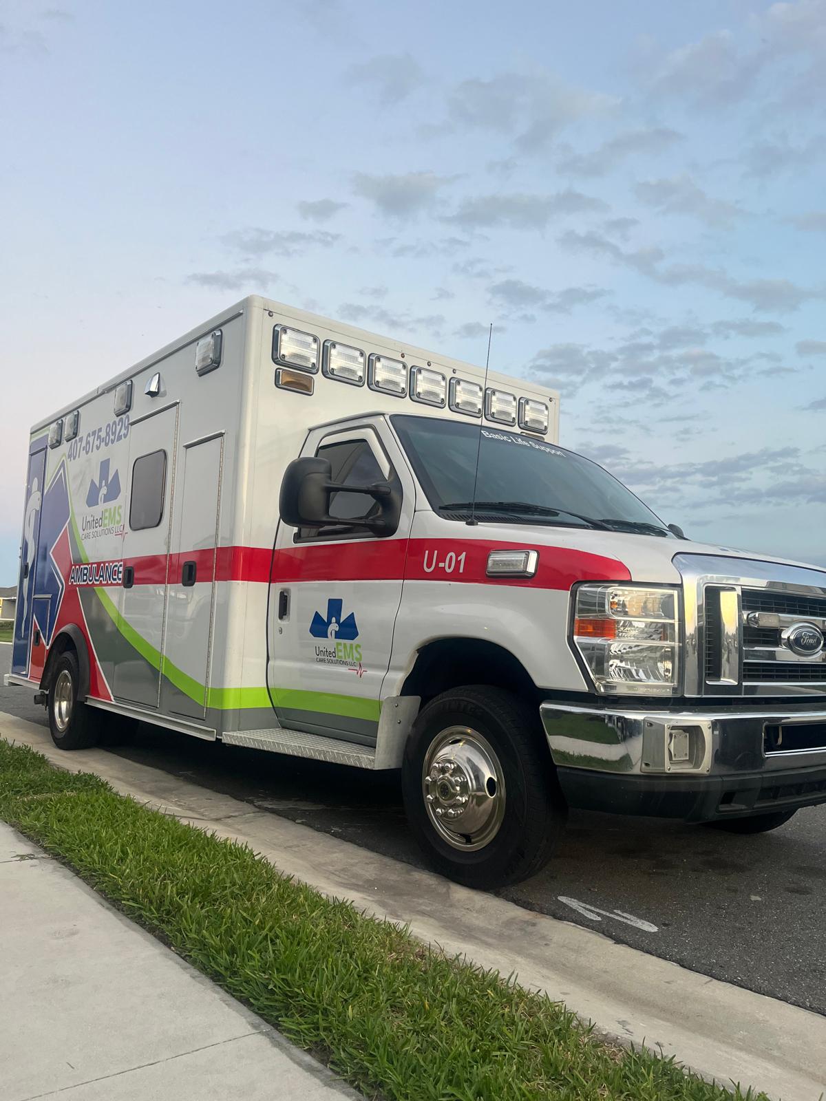 Front view of a United EMS Care Solutions ambulance ready for transport
